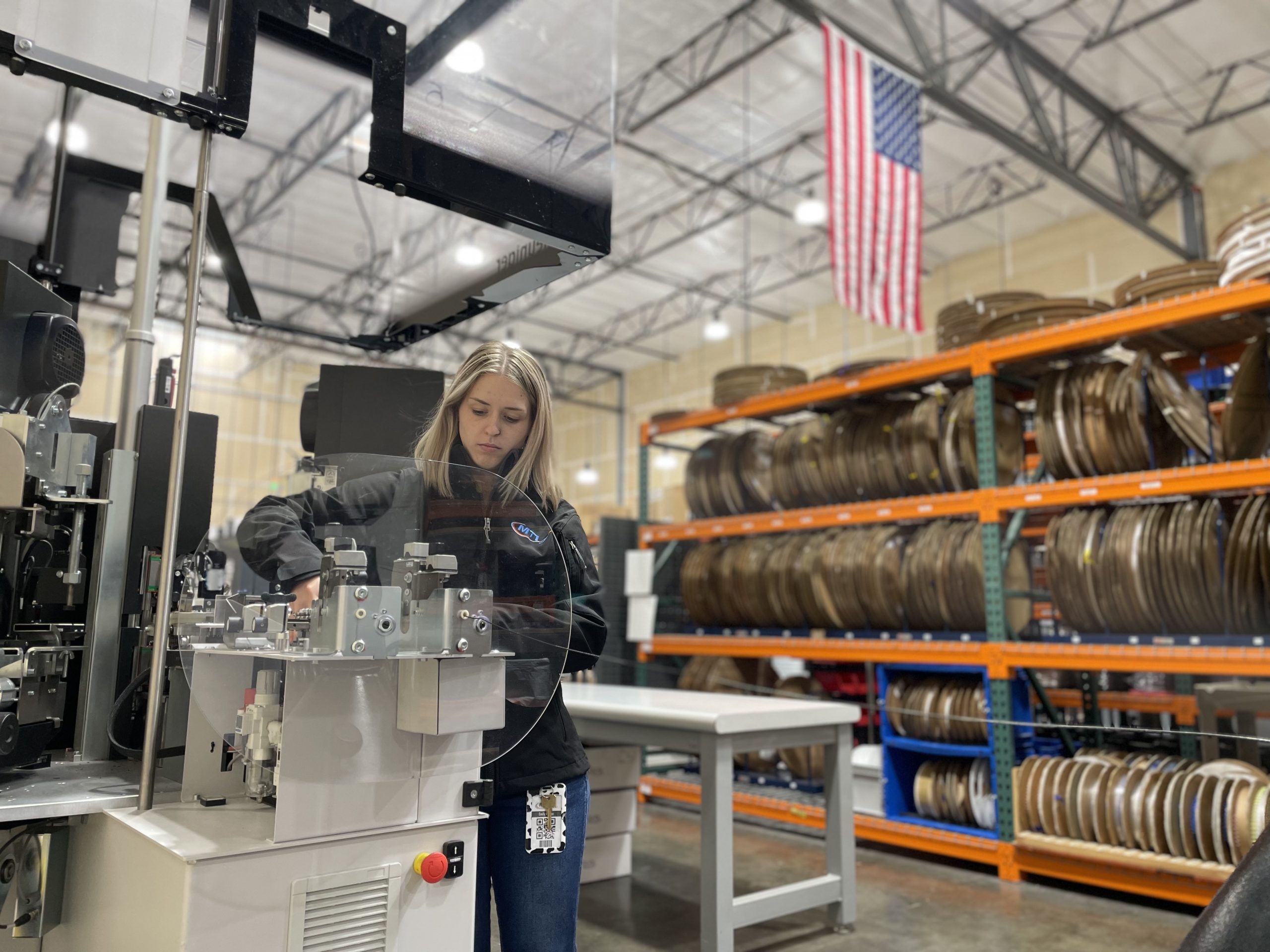 A female employee works at a CST machine.